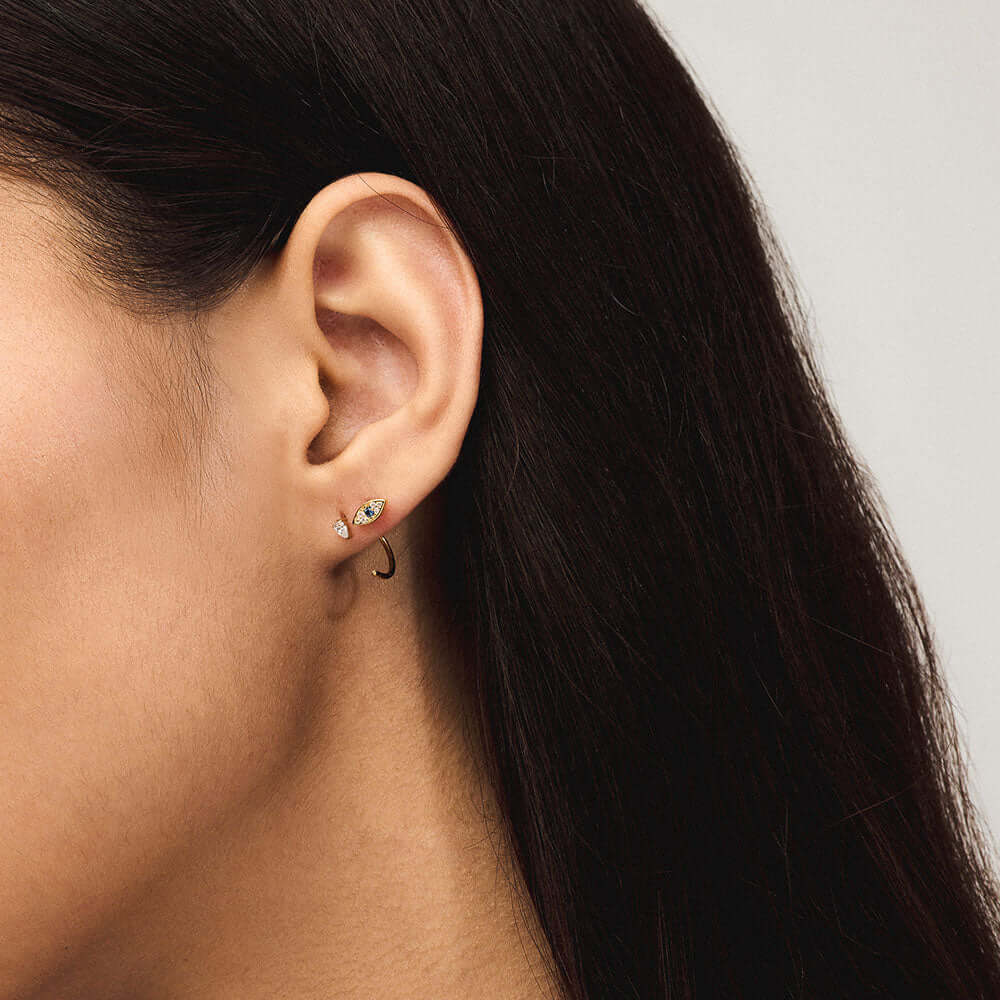 Crystal Pear Open Huggie Hoop in Titanium and Evil Eye Push Pin Flat Back Earring in Gold on model