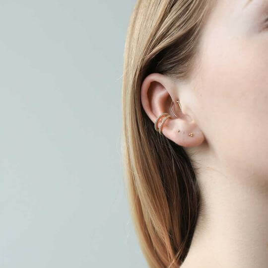 Tiny Trinity Threaded Flat Back Earring (Titanium - Gold) on model