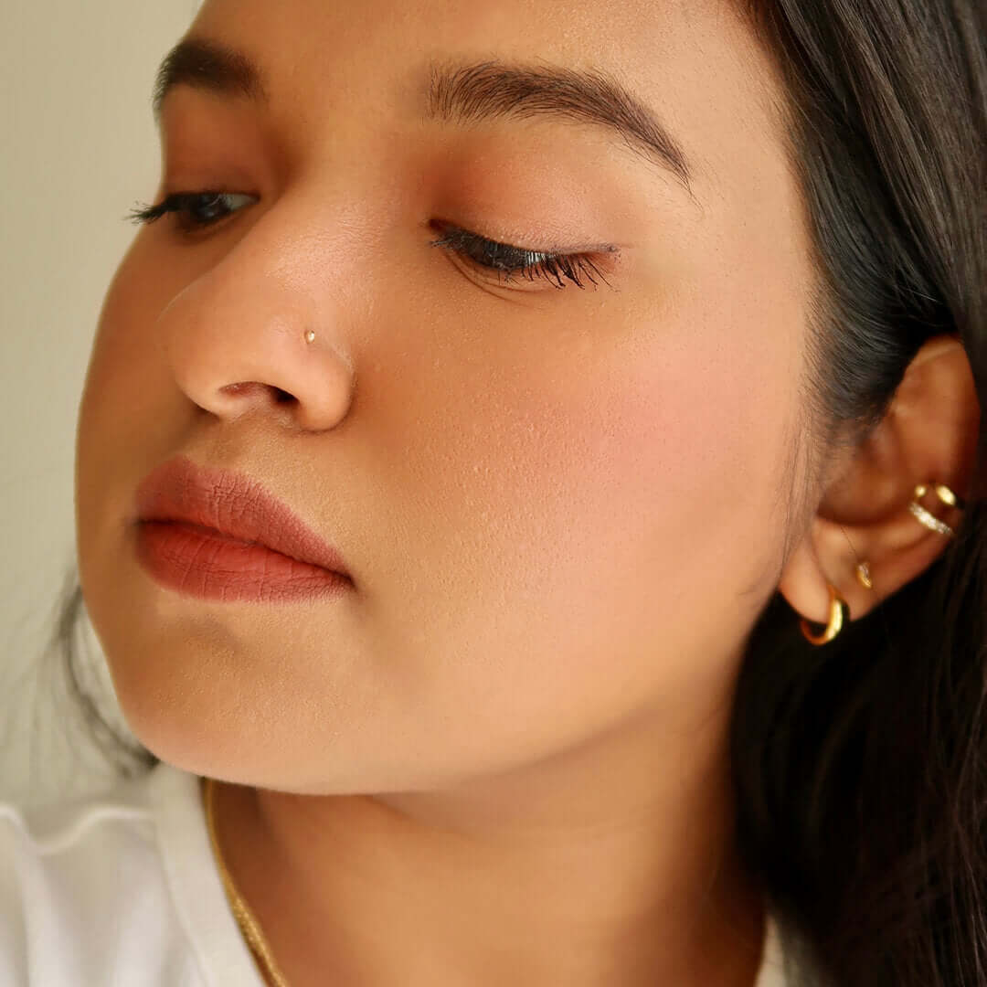 Tiny Secret Stud L-Shape Nose Ring in 14k Gold on model