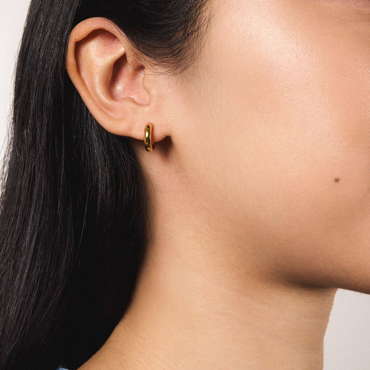 Bold Huggie Hoops in Titanium - Gold - On Model