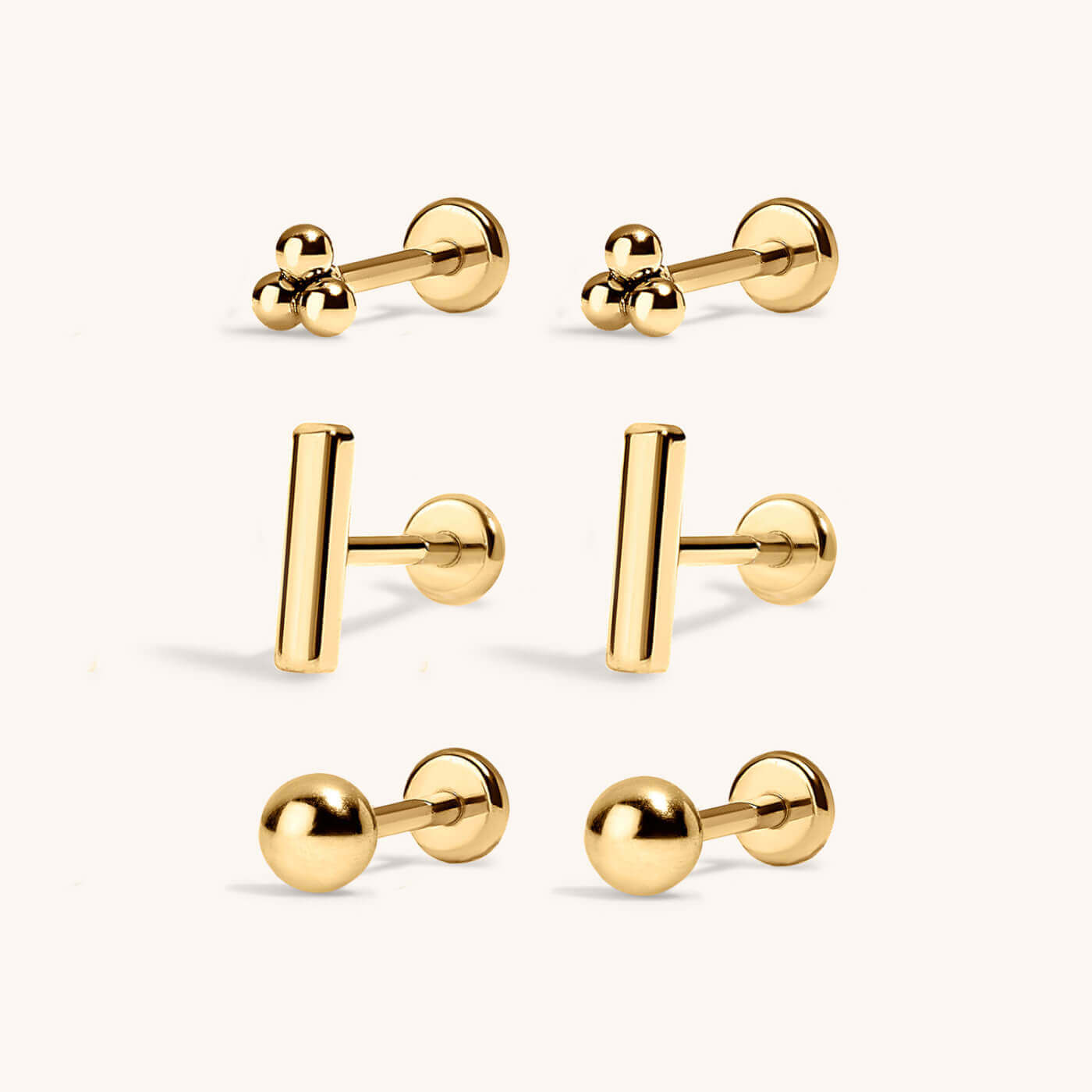 Minimalist Nap Earrings Trio in titanium (Gold) with Little Bar Nap Earrings, Tiny Trinity Nap Earrings, and Little Sphere Nap Earrings (Gold)