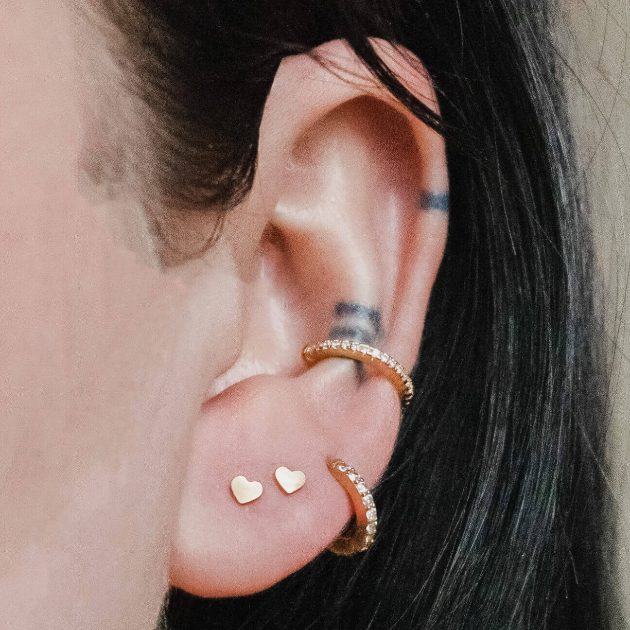 Classic Heart Studs in Titanium (Gold) on model