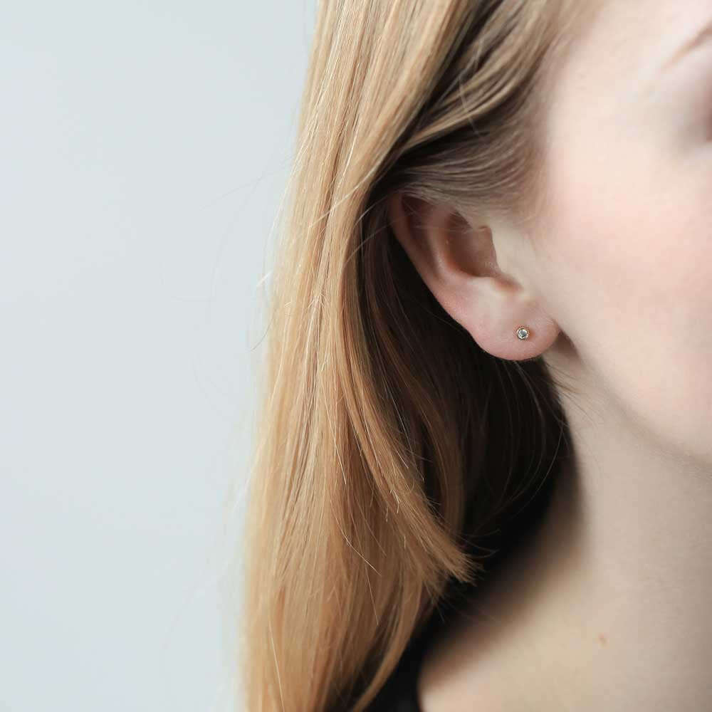 Tiny Diamond Studs in 14K Gold on model
